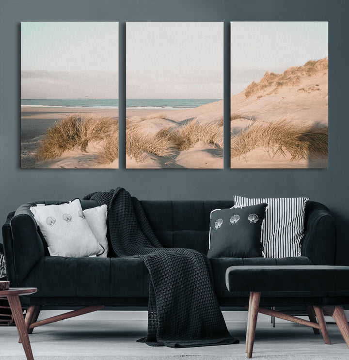 Soft pastel-toned beach scene with sand dunes, windswept grasses, and a calm ocean horizon, creating a serene coastal atmosphere.