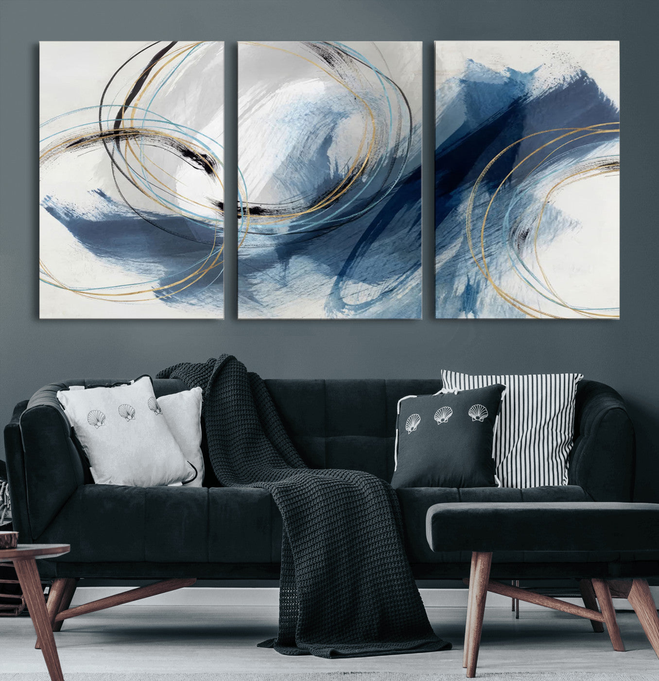 Abstract wall art featuring dynamic brush strokes in shades of blue and gray, overlaid with delicate circular line patterns in gold, black, and light blue on a white background.