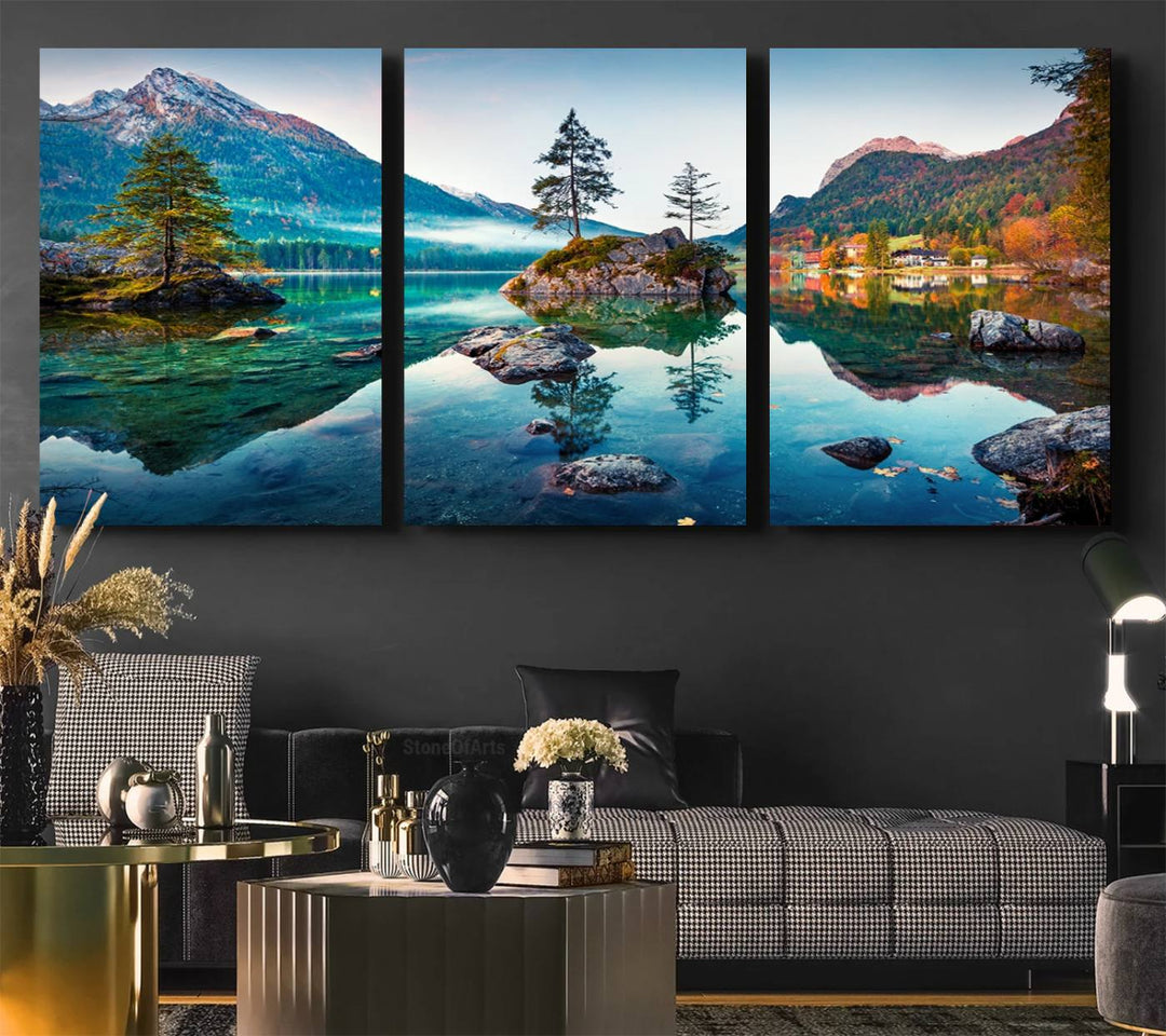 The 3-panel wall art showcases a serene mountain lake with rocky islands and trees, creating an ideal focal point for dining rooms or offices.