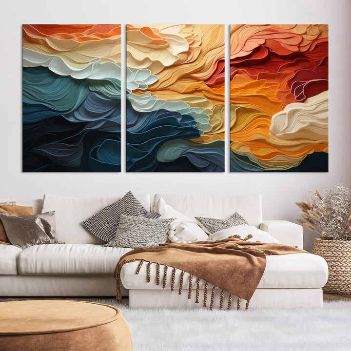 A Blue Orange Abstract Wave Wall Art Canvas Print adorns the wall. This colorful masterpiece is professionally hand-assembled to enhance any space.