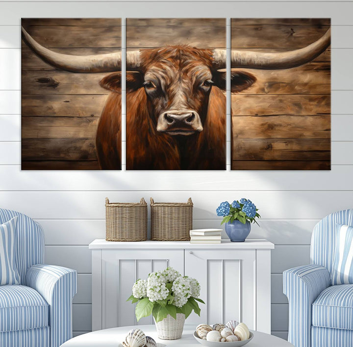 The Longhorn Bull Wall Art, a ready-to-hang canvas print, showcases an image of a brown longhorn cow set against a wooden background, perfect for those looking to enhance their space with rustic farmhouse and western barn decor.