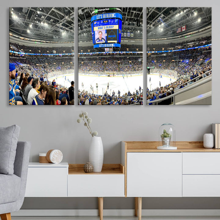 Wall art prints depicting the bustling scenes of the St. Louis Blues being cheered on by a full house at the Enterprise Center, beneath a large scoreboard.