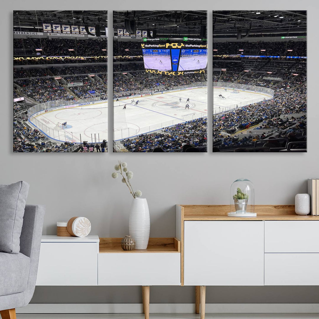 A large Enterprise Center canvas of a crowded hockey arena hangs prominently.