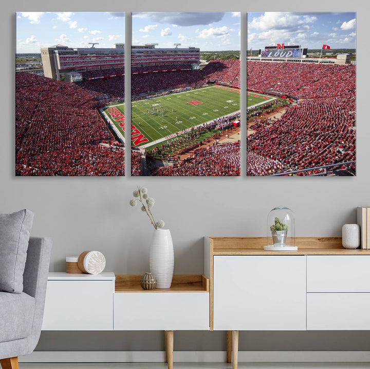 The University of Nebraska Cornhuskers Football Team Print showcases a vibrant triptych of Lincoln Memorial Stadium, depicting a packed football stadium filled with energetic fans. This handmade art piece is crafted in the USA and printed on premium canvas for a gallery-quality finish.