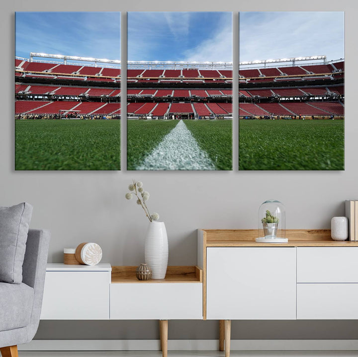 A canvas print of the University of Tulsa Golden Hurricane showcases H.A. Chapman Stadiums football field and red seats against a backdrop of a blue sky.