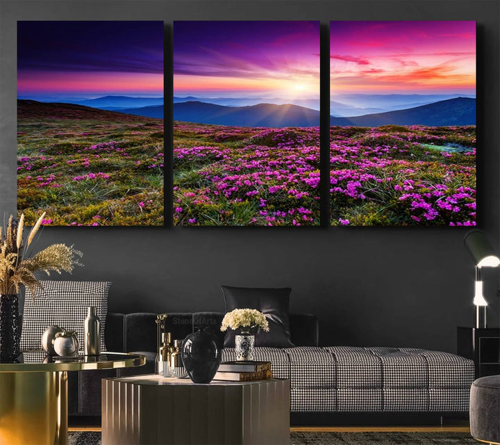 A 3-panel landscape photography canvas of a sunset over mountain meadows with purple wildflowers decorates the wall.