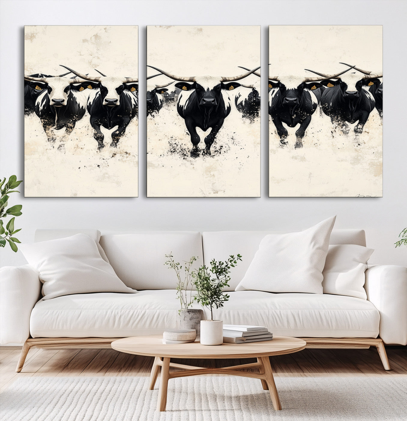 Canvas artwork of black and white Texas longhorns in a bold stampede over a minimalist background, ideal for rustic modern or Western-themed decor.