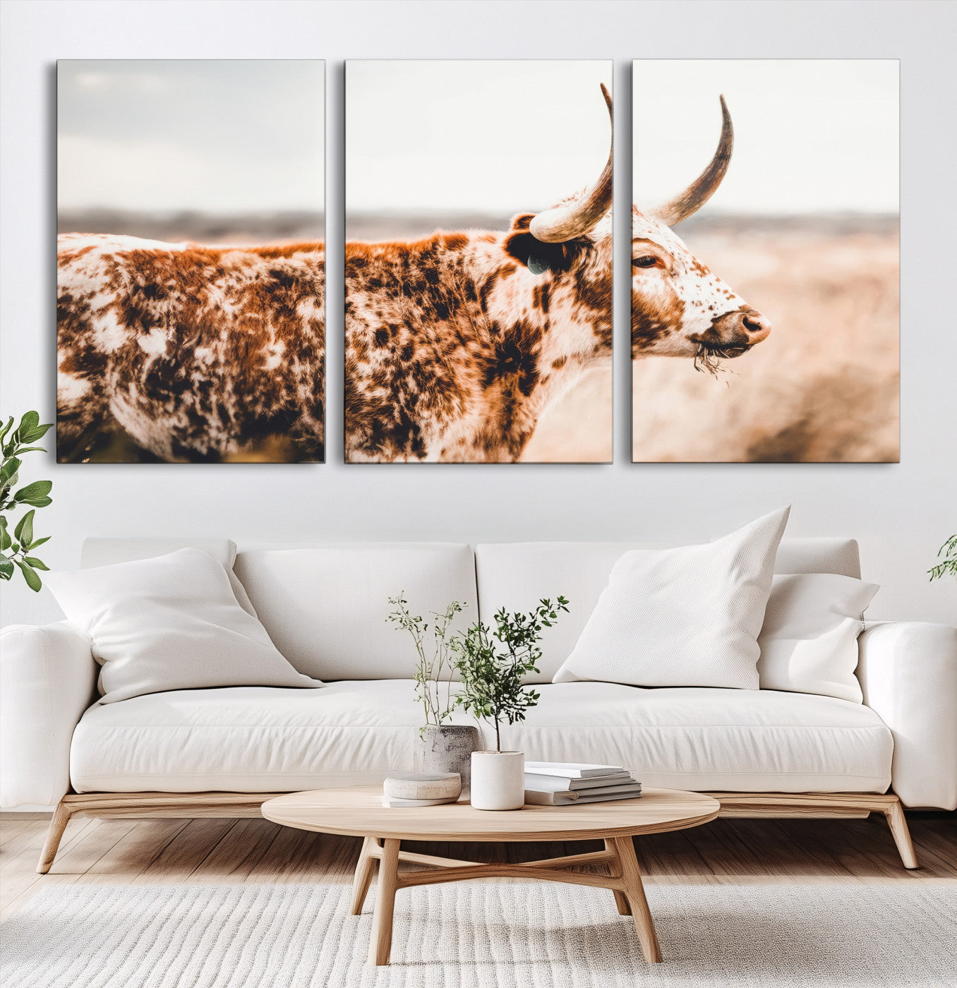 Speckled Texas longhorn with curved horns standing in a warm-toned prairie, perfect for rustic or country-style home decor.