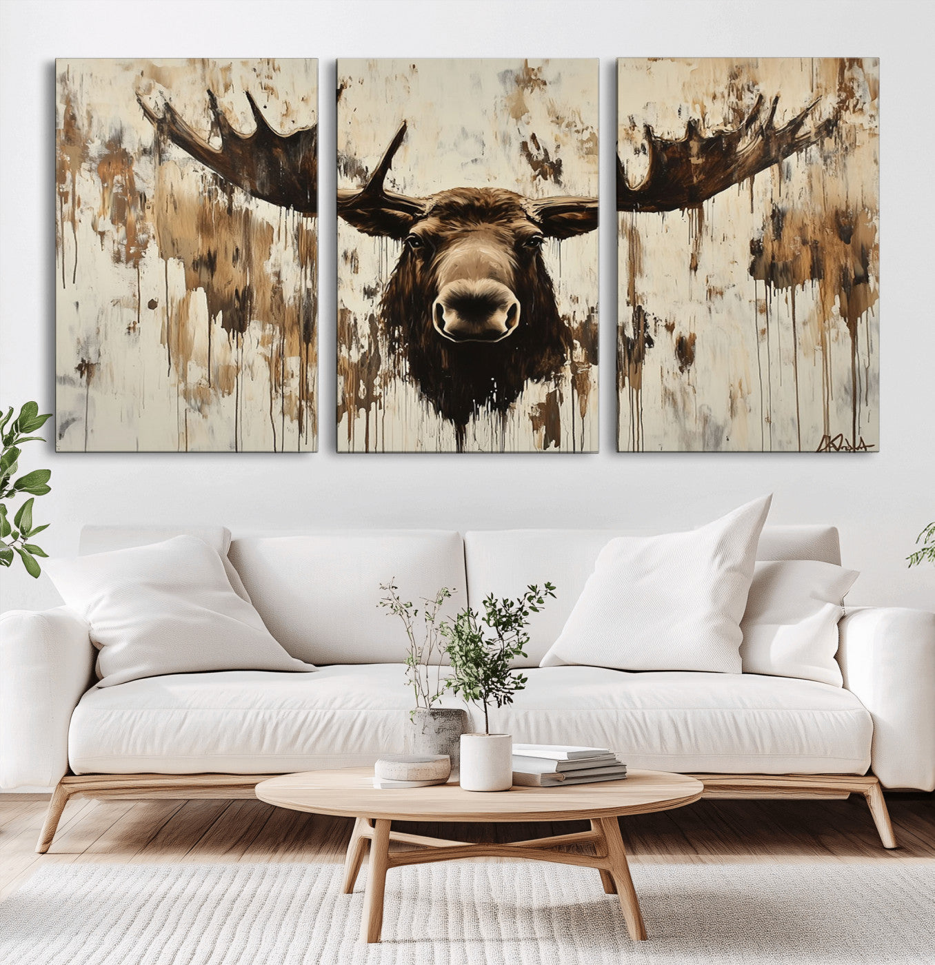 Expressive painting of a moose head with wide antlers in dark brown and beige tones, featuring paint drips and splatters on a light textured background, creating a striking rustic wall art canvas.