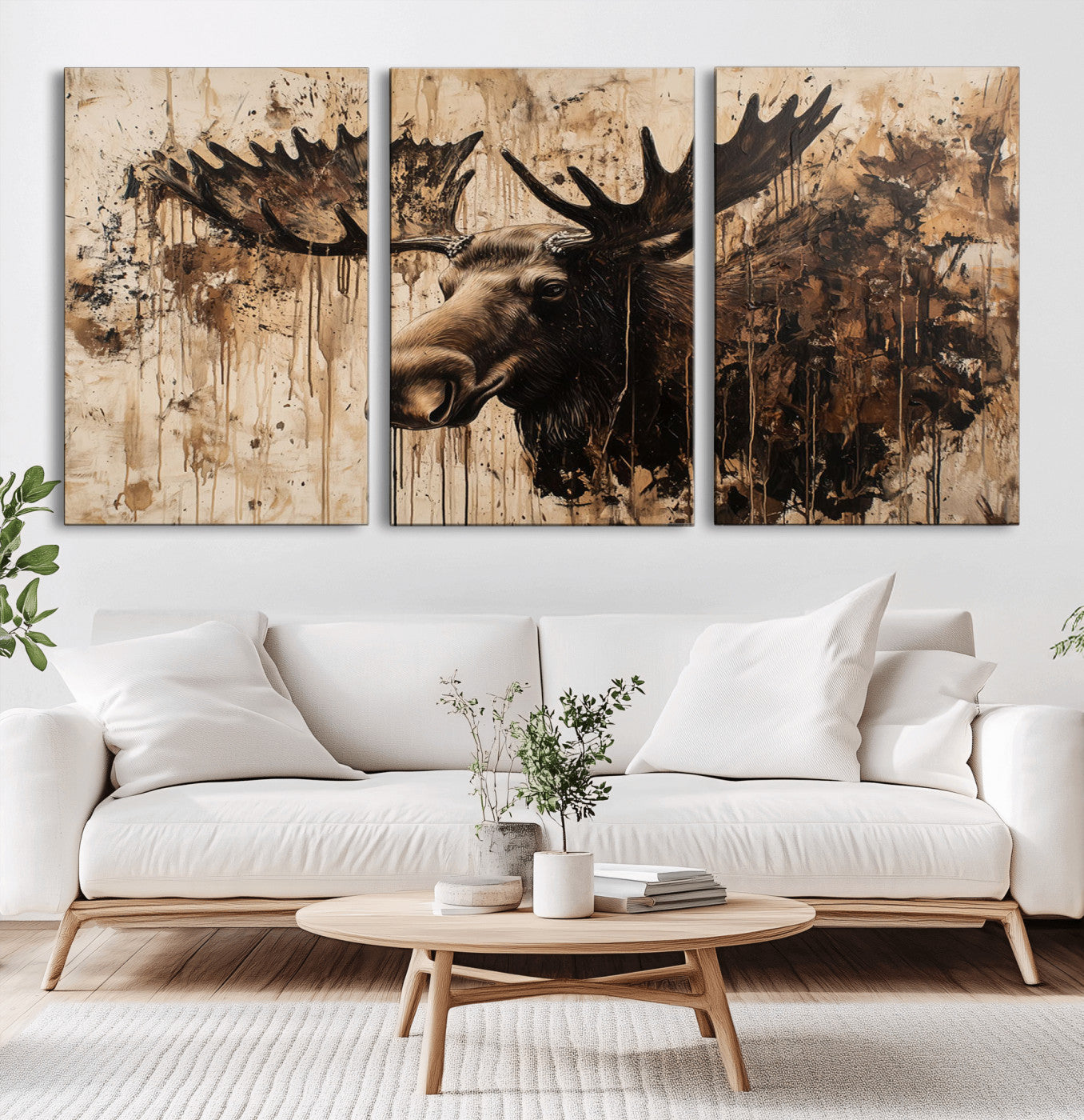 Artistic painting of a moose head with large antlers in shades of brown and black, with paint splatters and drips on a beige textured background, creating a rustic and expressive wall art canvas.