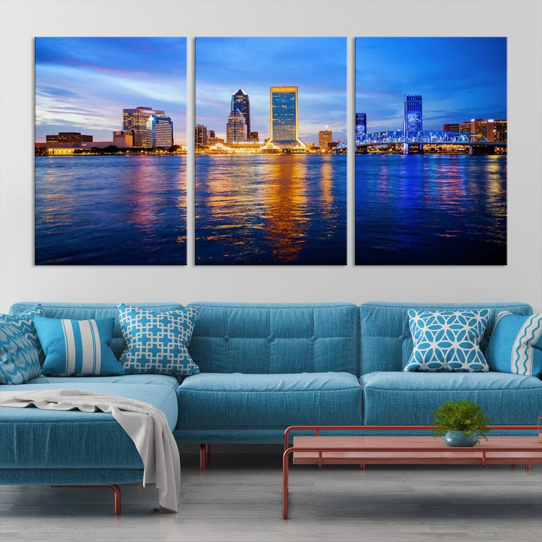 A cozy living room features the Jacksonville Wall Art Canvas Print, a large triptych crafted on museum-quality canvas that beautifully depicts the Jacksonville city skyline at sunset.