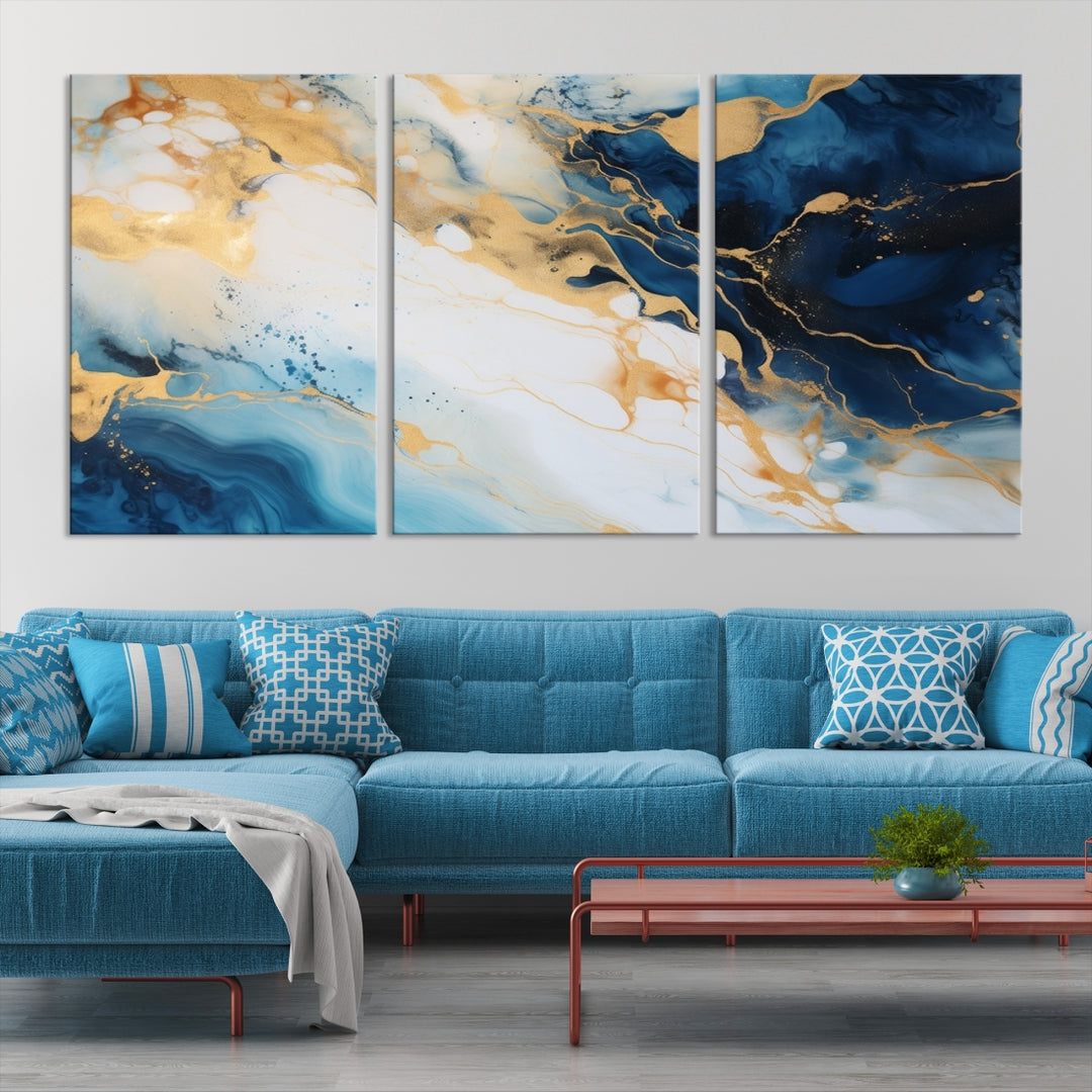 A modern living room featuring museum-quality Blue Gold Abstract Wall Art Print Contemporary art in a triptych arrangement.