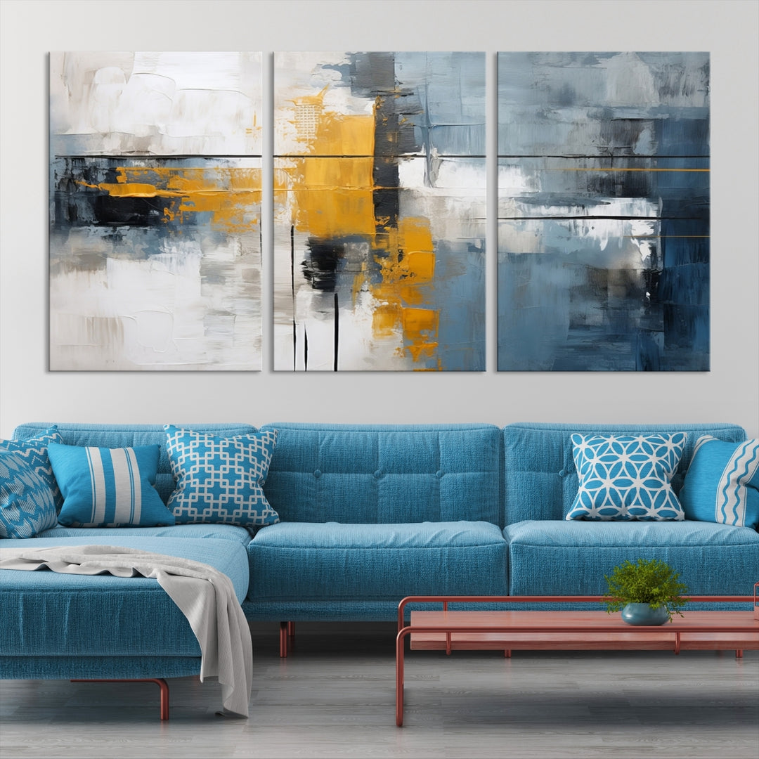 The Orange Abstract Wall Art Print features a series of white, blue, black, and yellow blocks arranged in a triptych format on museum-quality canvases. Proudly made in the USA and offered with free shipping.