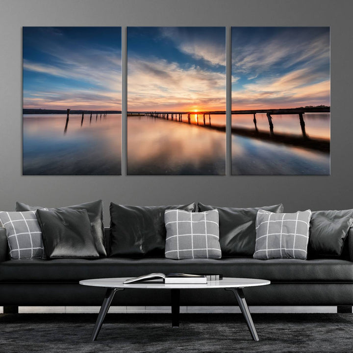 The Sunset Pier Canvas features a serene coastal landscape with vibrant hues under cloudy skies, ideal for modern decor.