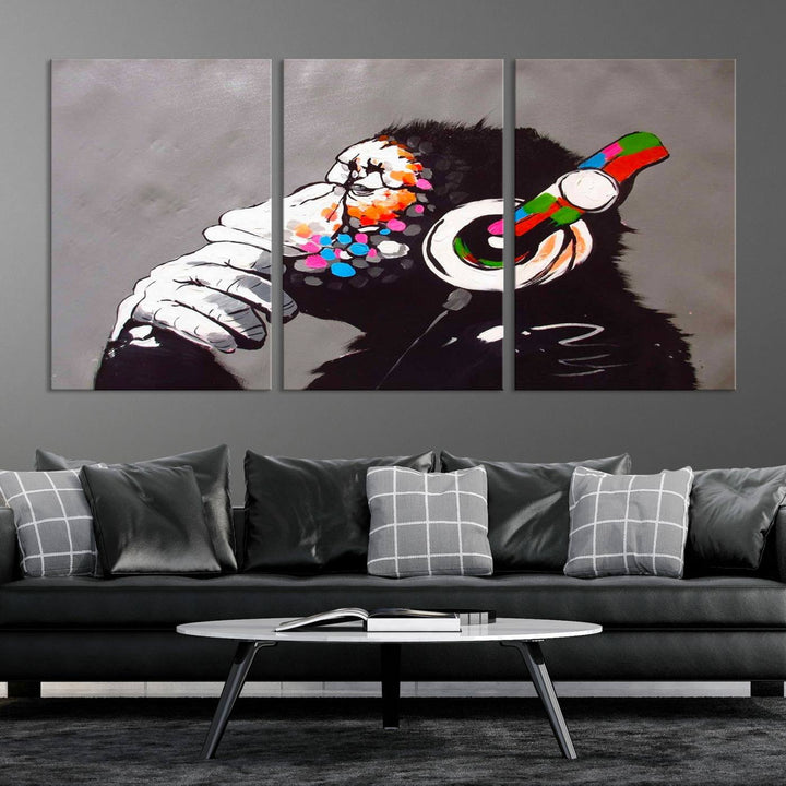 A vibrant triptych, the "DJ Monkey Listening to Music" wall art print, features a Banksy-inspired large canvas adorned with colorful modern pop art. This striking piece elegantly enhances the room with its dynamic and lively depiction.