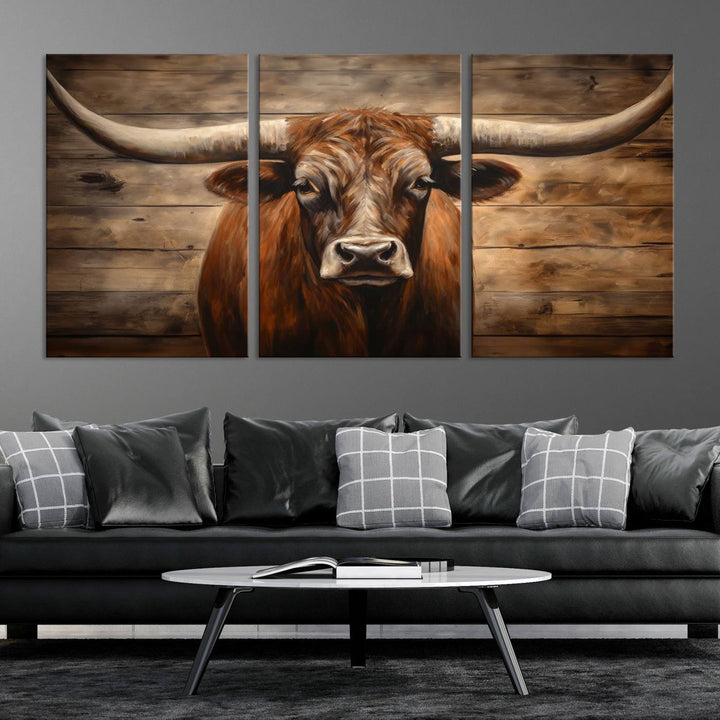 The Longhorn Bull Wall Art, a ready-to-hang canvas print, showcases an image of a brown longhorn cow set against a wooden background, perfect for those looking to enhance their space with rustic farmhouse and western barn decor.