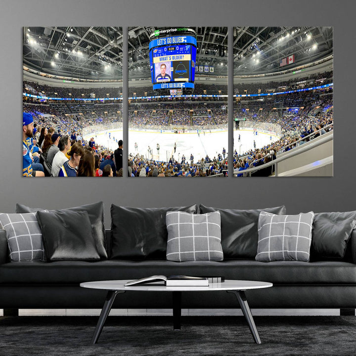 Wall art prints depicting the bustling scenes of the St. Louis Blues being cheered on by a full house at the Enterprise Center, beneath a large scoreboard.