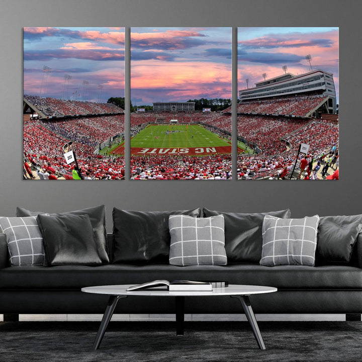 The wall art captures an NC State Wolfpack game under a vibrant sunset on triple canvas.