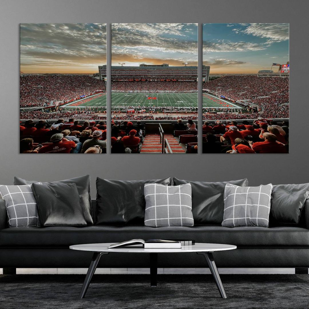 The living room features a stunning triptych of Lincoln Memorial Stadium wall art canvas print, celebrating the University of Nebraska Cornhuskers football team. This piece serves as captivating wall art, showcasing a gallery-quality finish.