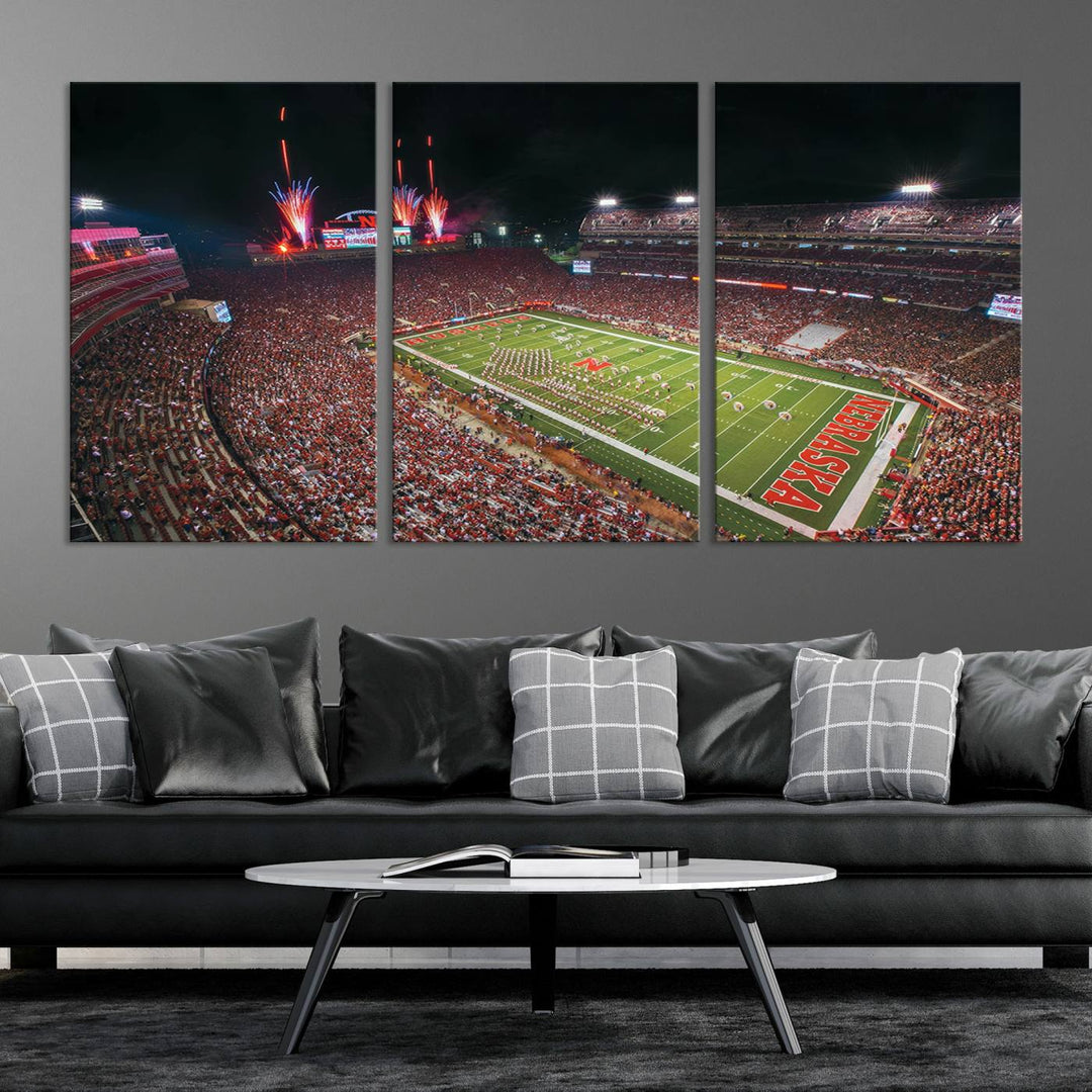 The University of Nebraska Cornhuskers Football Team Print, featuring Lincoln Memorial Stadium in a vibrant triptych canvas with fireworks above and a gallery-quality finish, is elegantly displayed.