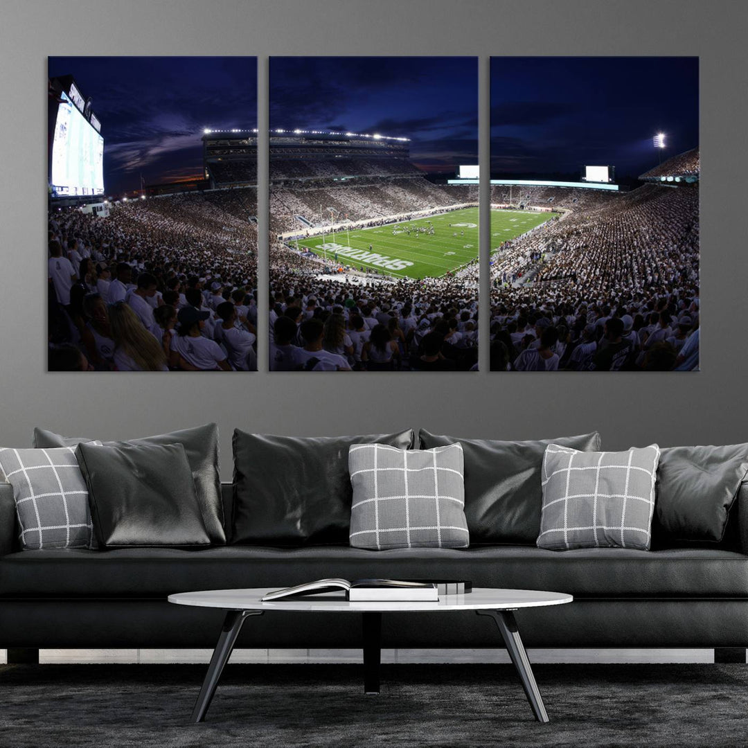 A packed football stadium at night, with bright lights and fans in white, depicted in a Michigan State Spartans Stadium wall art.