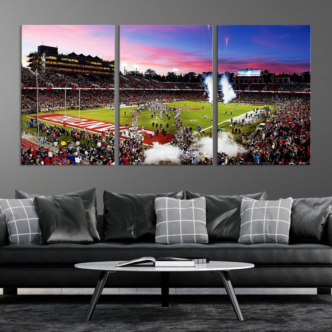 The wall art features a canvas print of the Stanford Cardinal football team, capturing players, fireworks, and smoke against the backdrop of a sunset at Stanford Stadium.