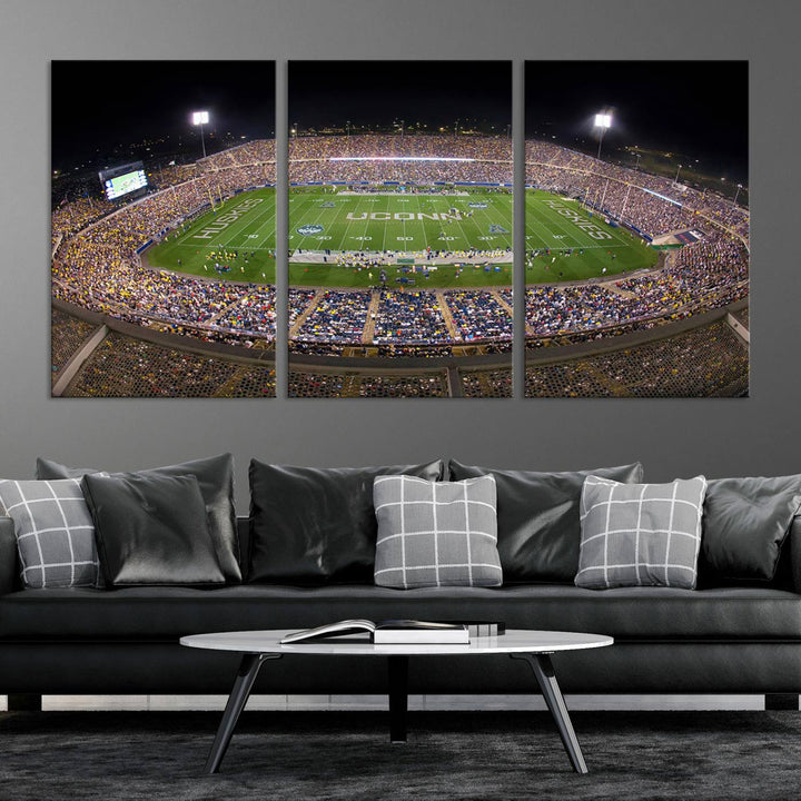 A large football stadium at night, featuring the UCONN Huskies, is depicted on the East Hartford Pratt & Whitney Stadium Wall Art Canvas Print.