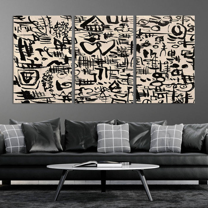 The Abstract Love and Chaos canvas is a museum-quality print featuring black symbols on a beige background, adorned with a heart and scribble design. It is framed to enhance its artistic appeal.