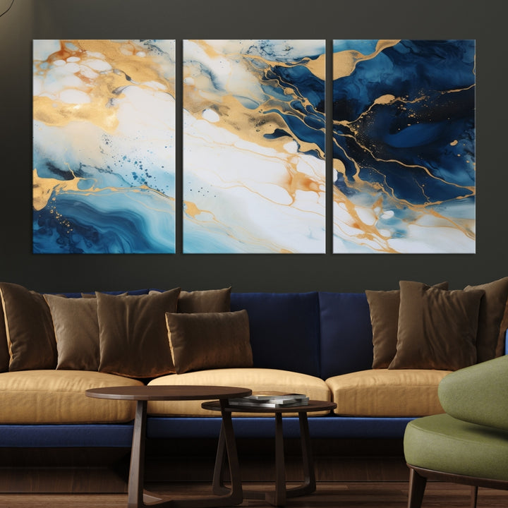 A modern living room featuring museum-quality Blue Gold Abstract Wall Art Print Contemporary art in a triptych arrangement.