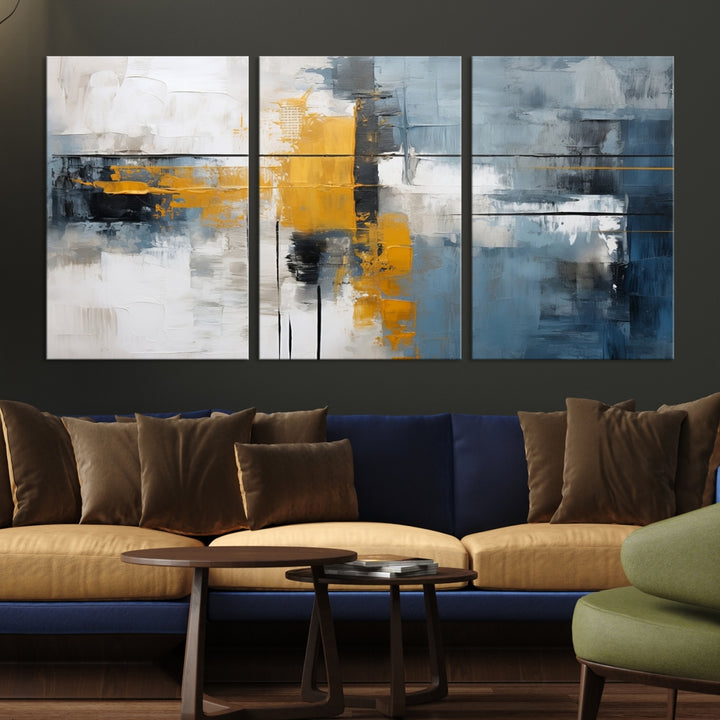 The Orange Abstract Wall Art Print features a series of white, blue, black, and yellow blocks arranged in a triptych format on museum-quality canvases. Proudly made in the USA and offered with free shipping.