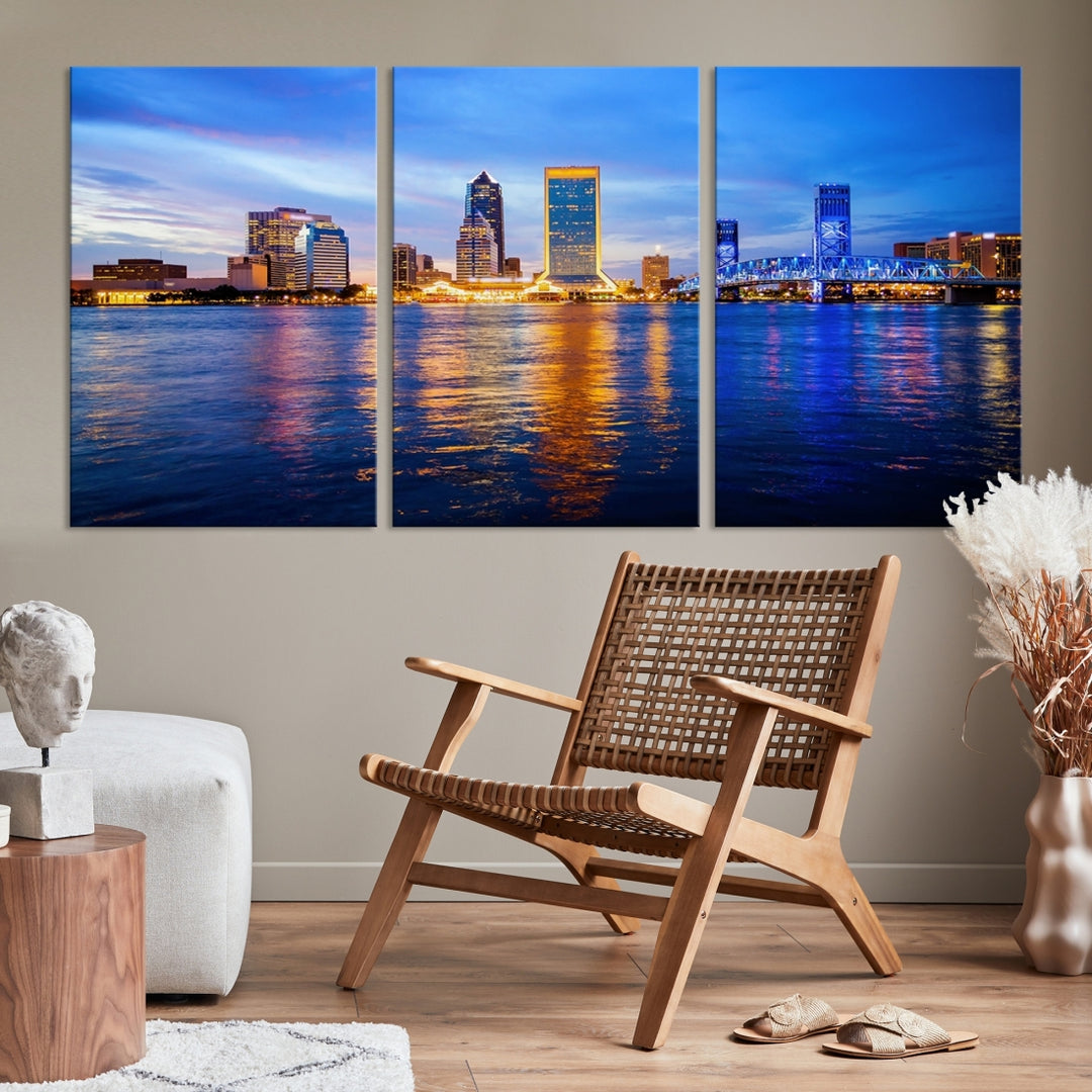 A cozy living room features the Jacksonville Wall Art Canvas Print, a large triptych crafted on museum-quality canvas that beautifully depicts the Jacksonville city skyline at sunset.