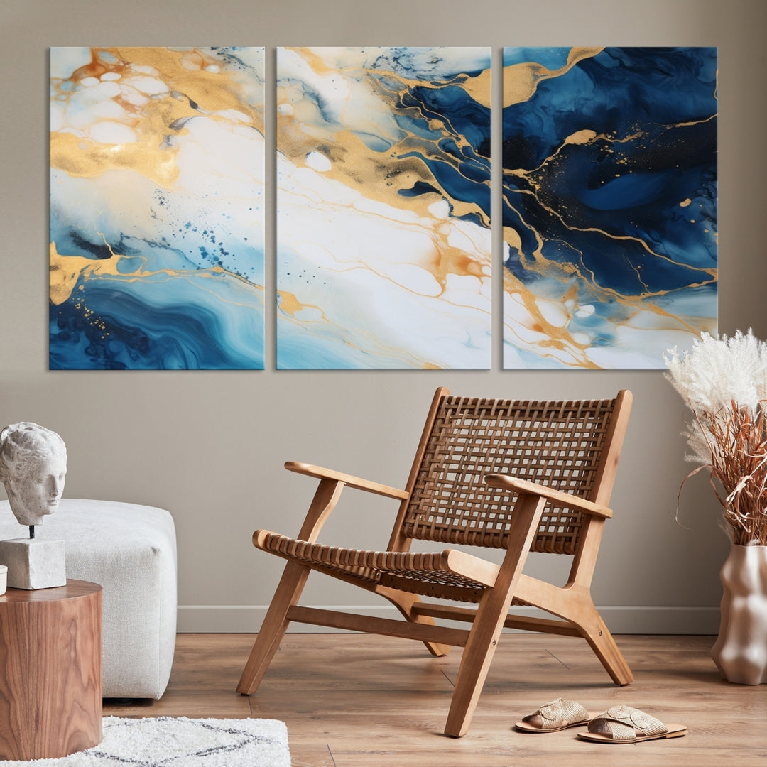 A modern living room featuring museum-quality Blue Gold Abstract Wall Art Print Contemporary art in a triptych arrangement.