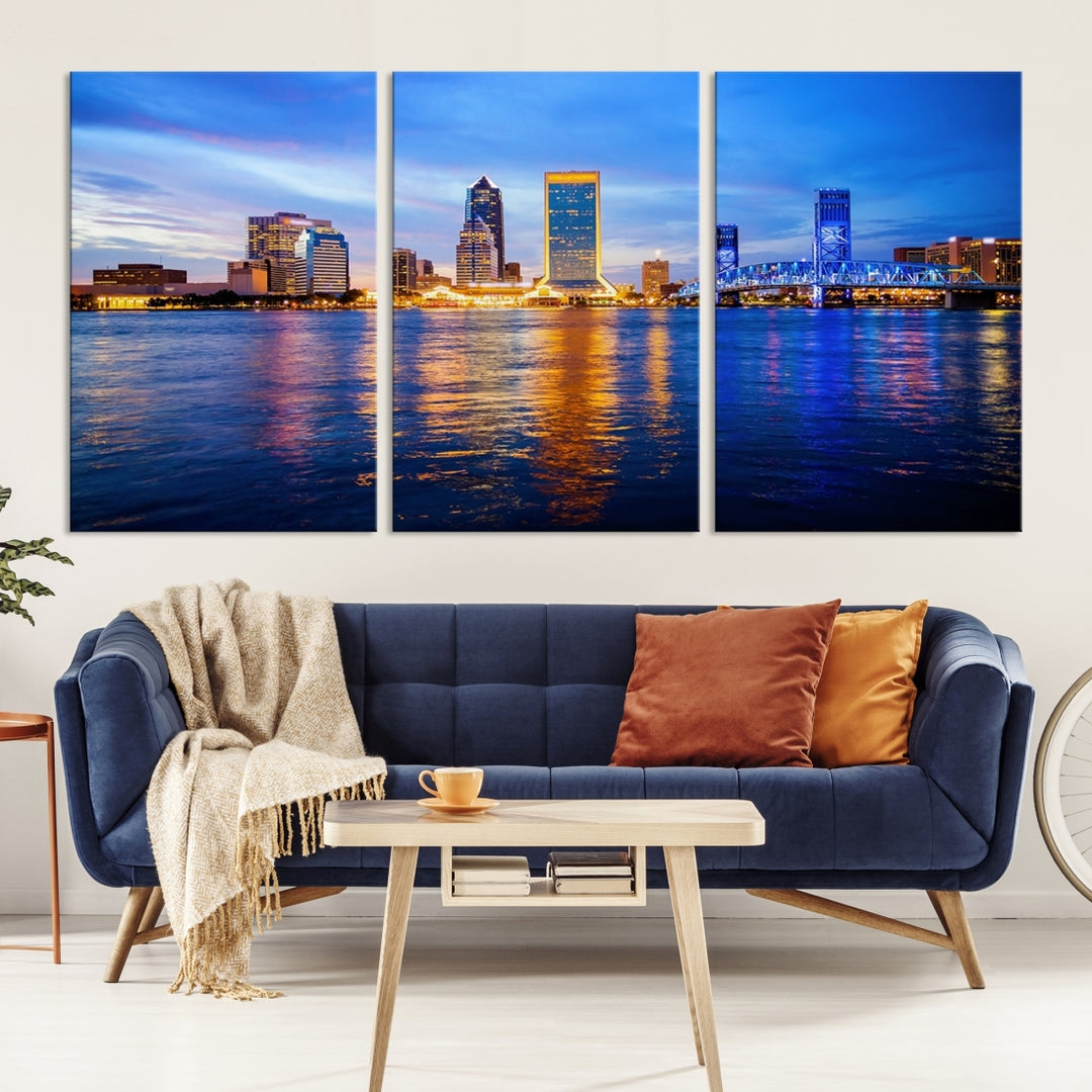 A cozy living room features the Jacksonville Wall Art Canvas Print, a large triptych crafted on museum-quality canvas that beautifully depicts the Jacksonville city skyline at sunset.