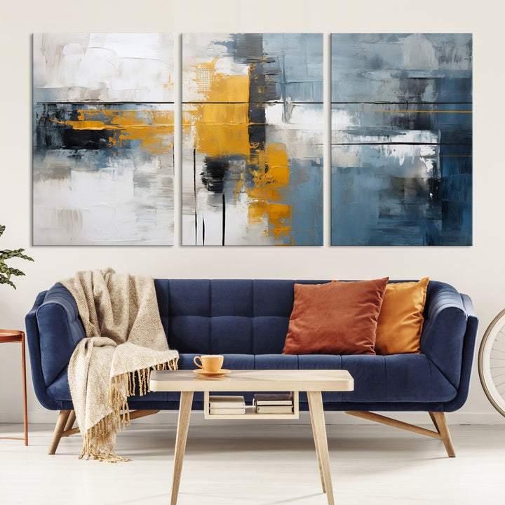 The Orange Abstract Wall Art Print features a series of white, blue, black, and yellow blocks arranged in a triptych format on museum-quality canvases. Proudly made in the USA and offered with free shipping.