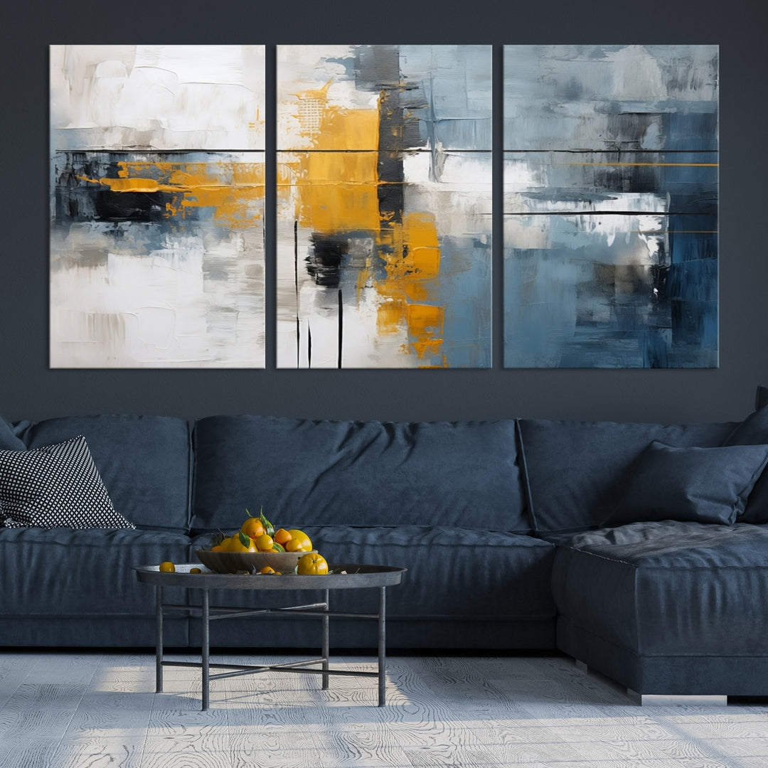 The Orange Abstract Wall Art Print features a series of white, blue, black, and yellow blocks arranged in a triptych format on museum-quality canvases. Proudly made in the USA and offered with free shipping.