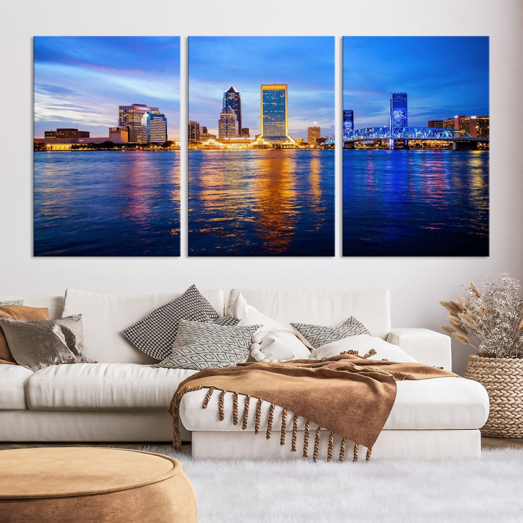 A cozy living room features the Jacksonville Wall Art Canvas Print, a large triptych crafted on museum-quality canvas that beautifully depicts the Jacksonville city skyline at sunset.