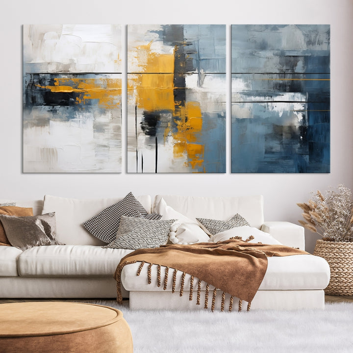 The Orange Abstract Wall Art Print features a series of white, blue, black, and yellow blocks arranged in a triptych format on museum-quality canvases. Proudly made in the USA and offered with free shipping.