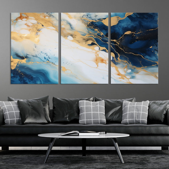 A modern living room featuring museum-quality Blue Gold Abstract Wall Art Print Contemporary art in a triptych arrangement.