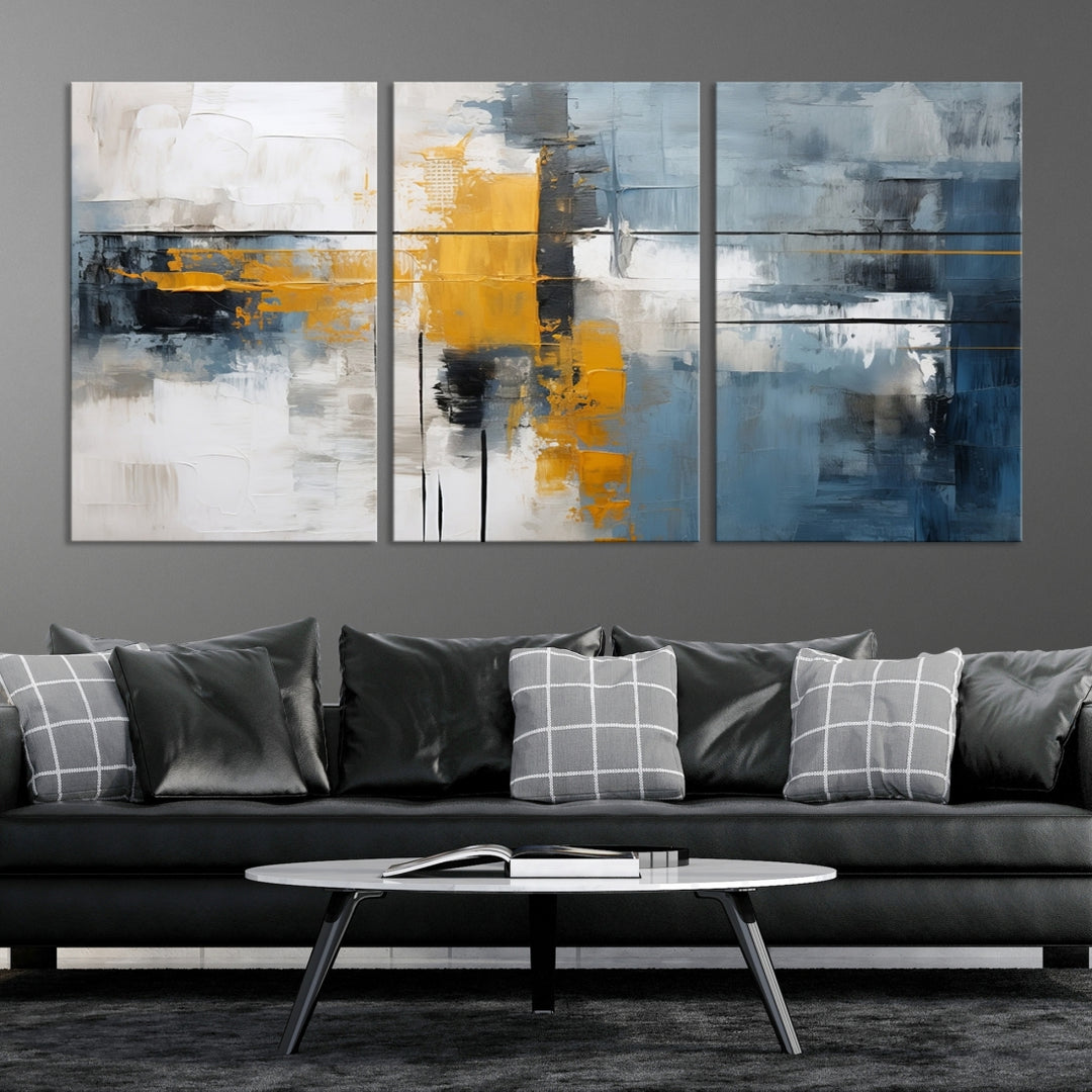 The Orange Abstract Wall Art Print features a series of white, blue, black, and yellow blocks arranged in a triptych format on museum-quality canvases. Proudly made in the USA and offered with free shipping.