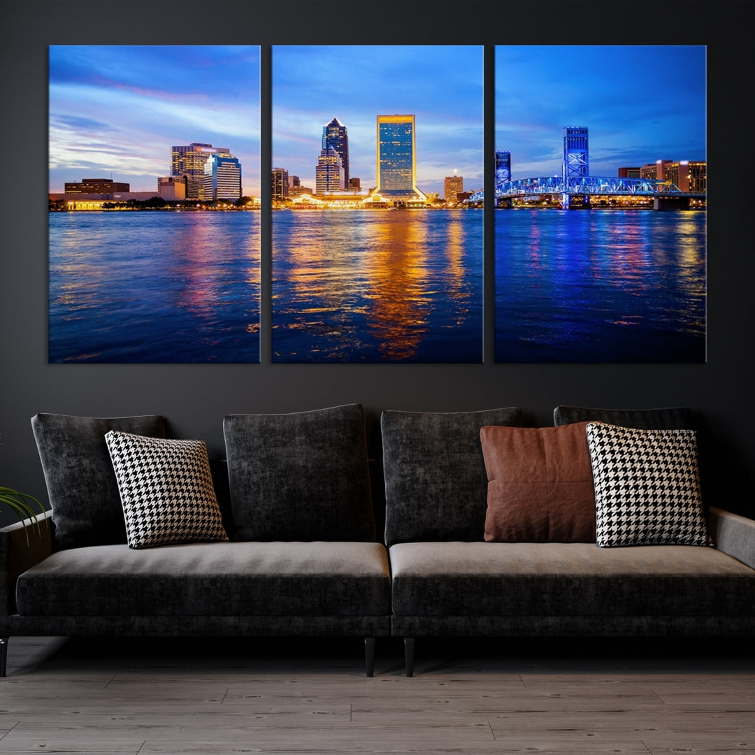 A cozy living room features the Jacksonville Wall Art Canvas Print, a large triptych crafted on museum-quality canvas that beautifully depicts the Jacksonville city skyline at sunset.