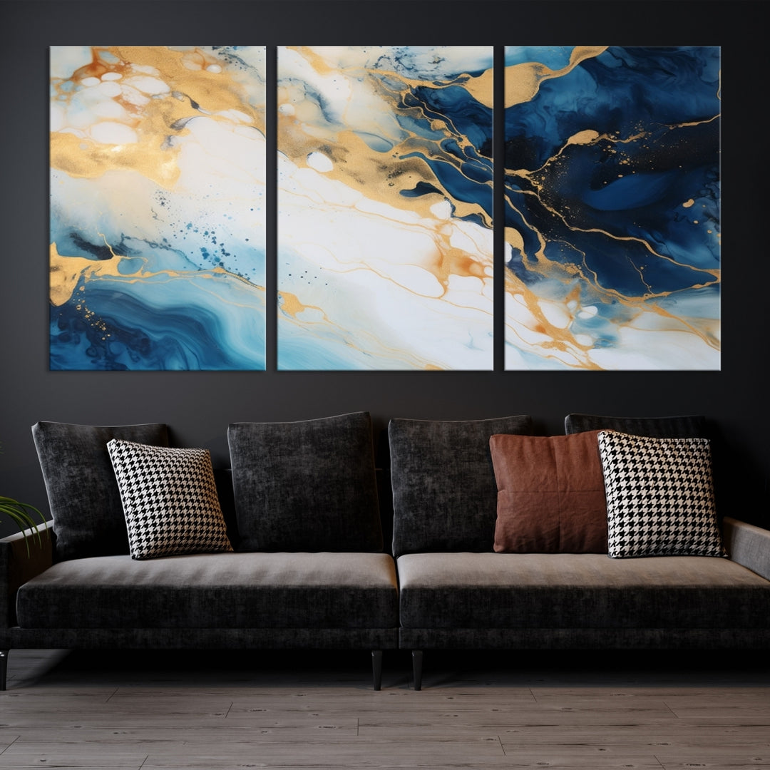 A modern living room featuring museum-quality Blue Gold Abstract Wall Art Print Contemporary art in a triptych arrangement.