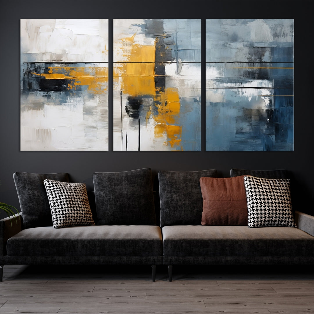 The Orange Abstract Wall Art Print features a series of white, blue, black, and yellow blocks arranged in a triptych format on museum-quality canvases. Proudly made in the USA and offered with free shipping.