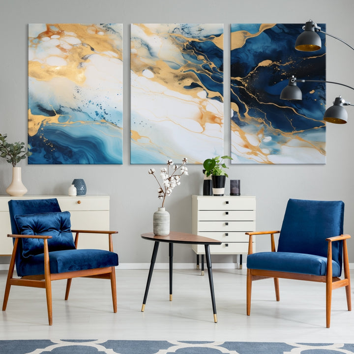 A modern living room featuring museum-quality Blue Gold Abstract Wall Art Print Contemporary art in a triptych arrangement.