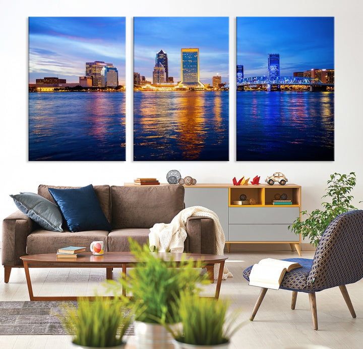 A cozy living room features the Jacksonville Wall Art Canvas Print, a large triptych crafted on museum-quality canvas that beautifully depicts the Jacksonville city skyline at sunset.