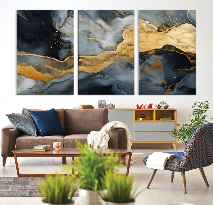 The living room features the Golden Gray Abstract Wall Art Print Contemporary Art Canvas Design, a triptych showcasing gold, black, and gray swirls. Crafted on museum-quality canvas and ready to hang, this piece is designed for elegance and durability.