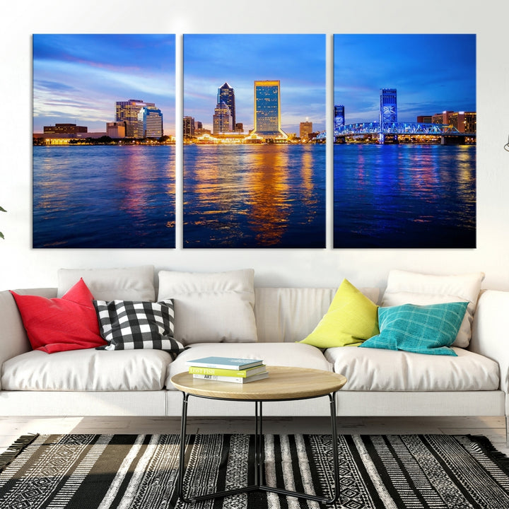 A cozy living room features the Jacksonville Wall Art Canvas Print, a large triptych crafted on museum-quality canvas that beautifully depicts the Jacksonville city skyline at sunset.