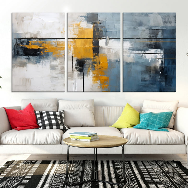 The Orange Abstract Wall Art Print features a series of white, blue, black, and yellow blocks arranged in a triptych format on museum-quality canvases. Proudly made in the USA and offered with free shipping.