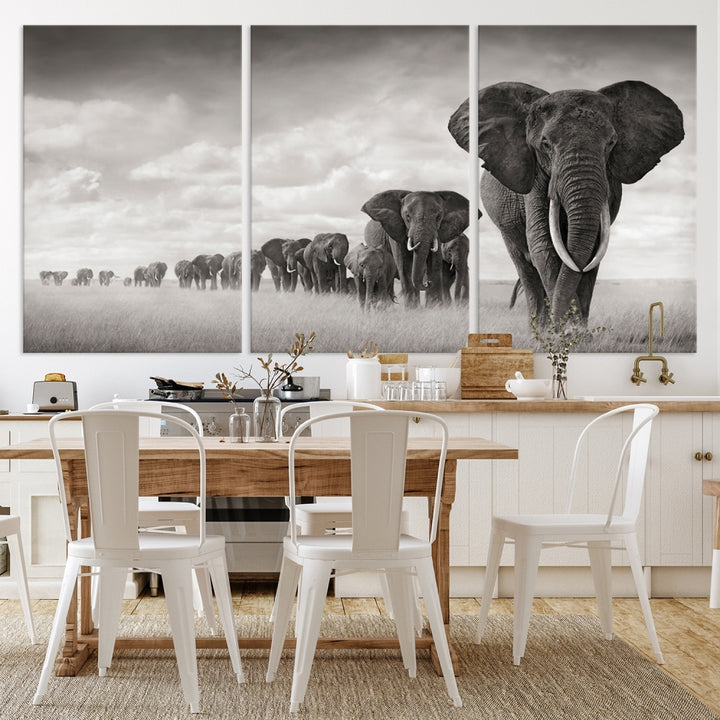 The "Herd of Elephants Wall Art Canvas Print" features an elegant black and white triptych of elephants walking in a line, beautifully displayed on museum-quality canvas with a UV-protective coating. This artwork arrives ready to hang and adds sophistication to any space.