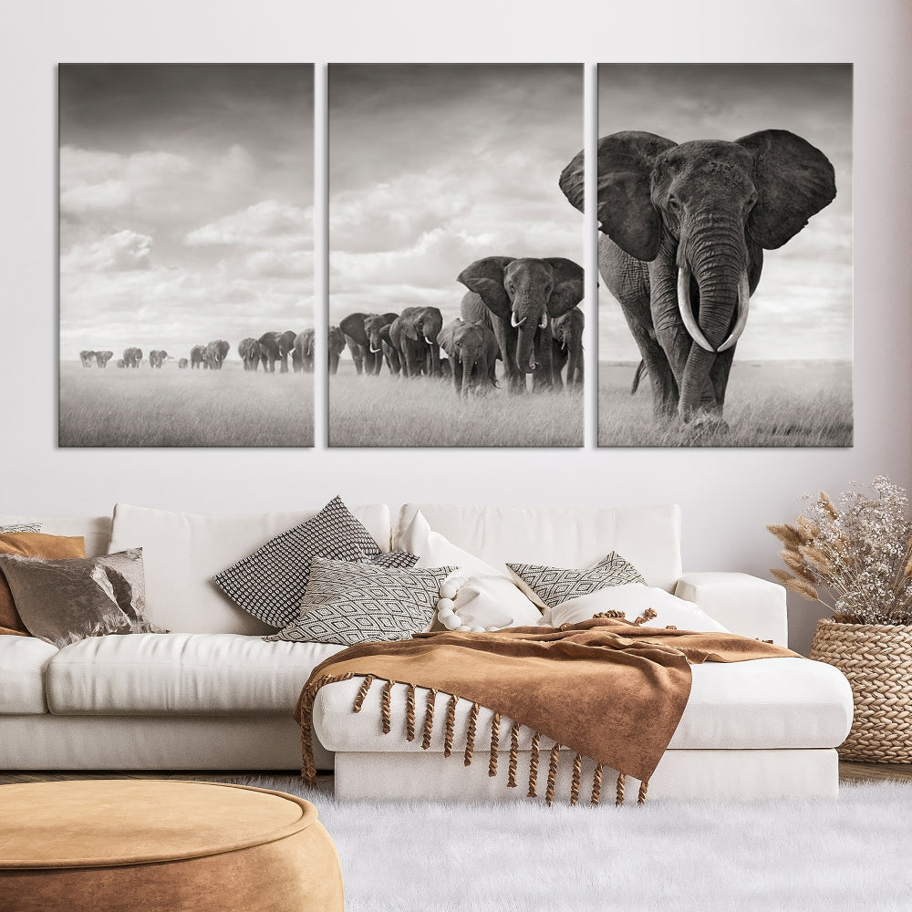 The "Herd of Elephants Wall Art Canvas Print" features an elegant black and white triptych of elephants walking in a line, beautifully displayed on museum-quality canvas with a UV-protective coating. This artwork arrives ready to hang and adds sophistication to any space.