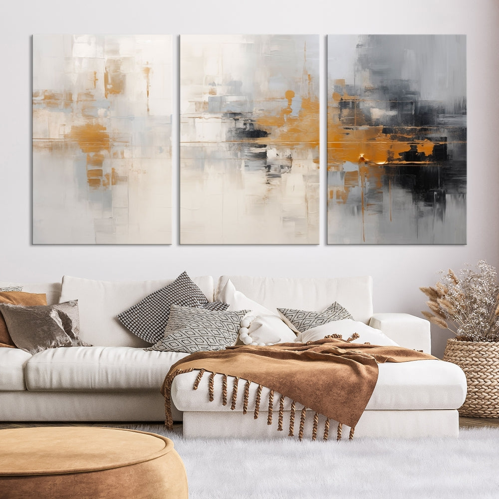 The Orange Pastel Abstract Wall Art Canvas Print, featuring a triptych of orange, white, and black hues, is elegantly displayed on museum-quality canvas.